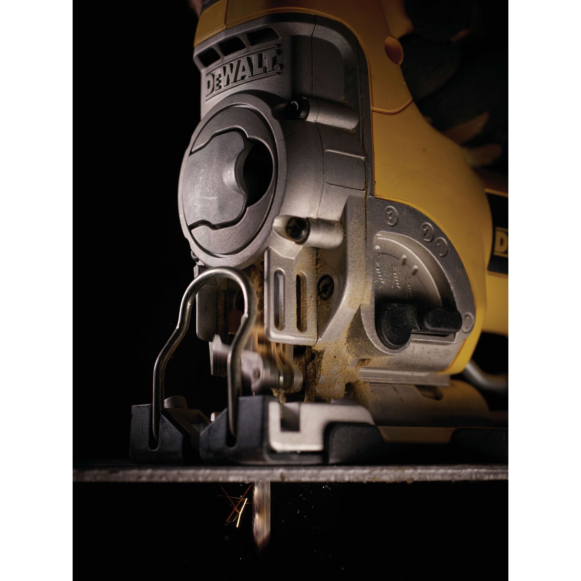 Close-up of a DEWALT jigsaw in use, cutting material. Tool details and blade are visible.