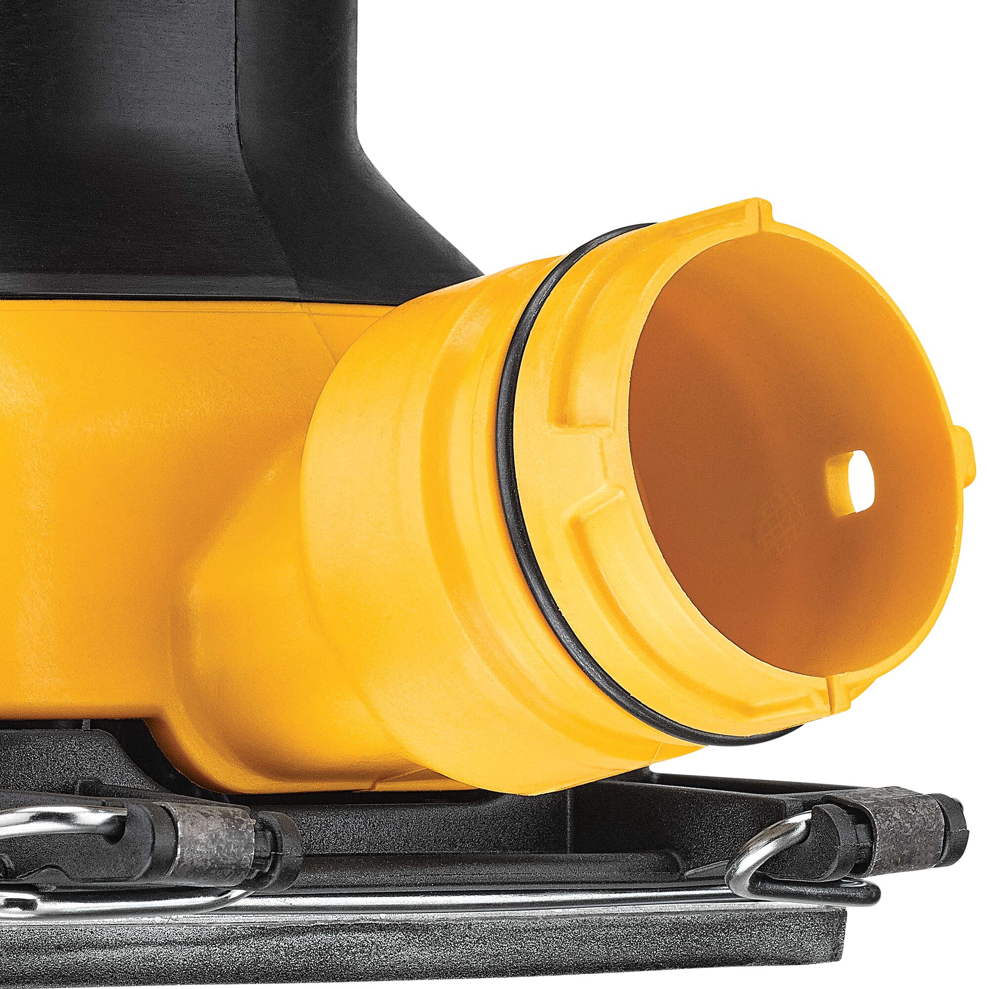 Close-up view of a yellow and black DEWALT power tool part, showing a cylindrical dust port attachment.