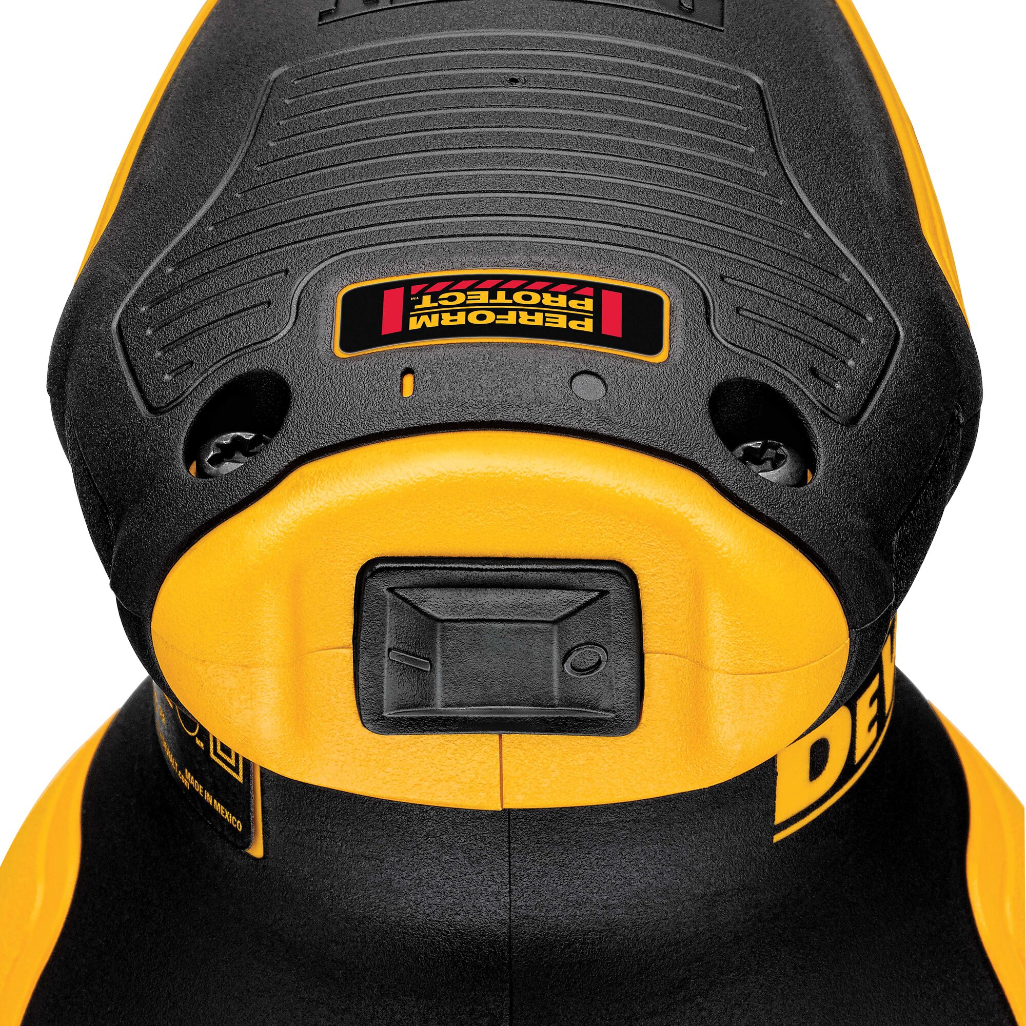 Close-up view of a DEWALT power tool, showing the top part of the tool with a textured black and yellow surface, a rectangular button, and a label marked 'PERFORM PROTECT.'