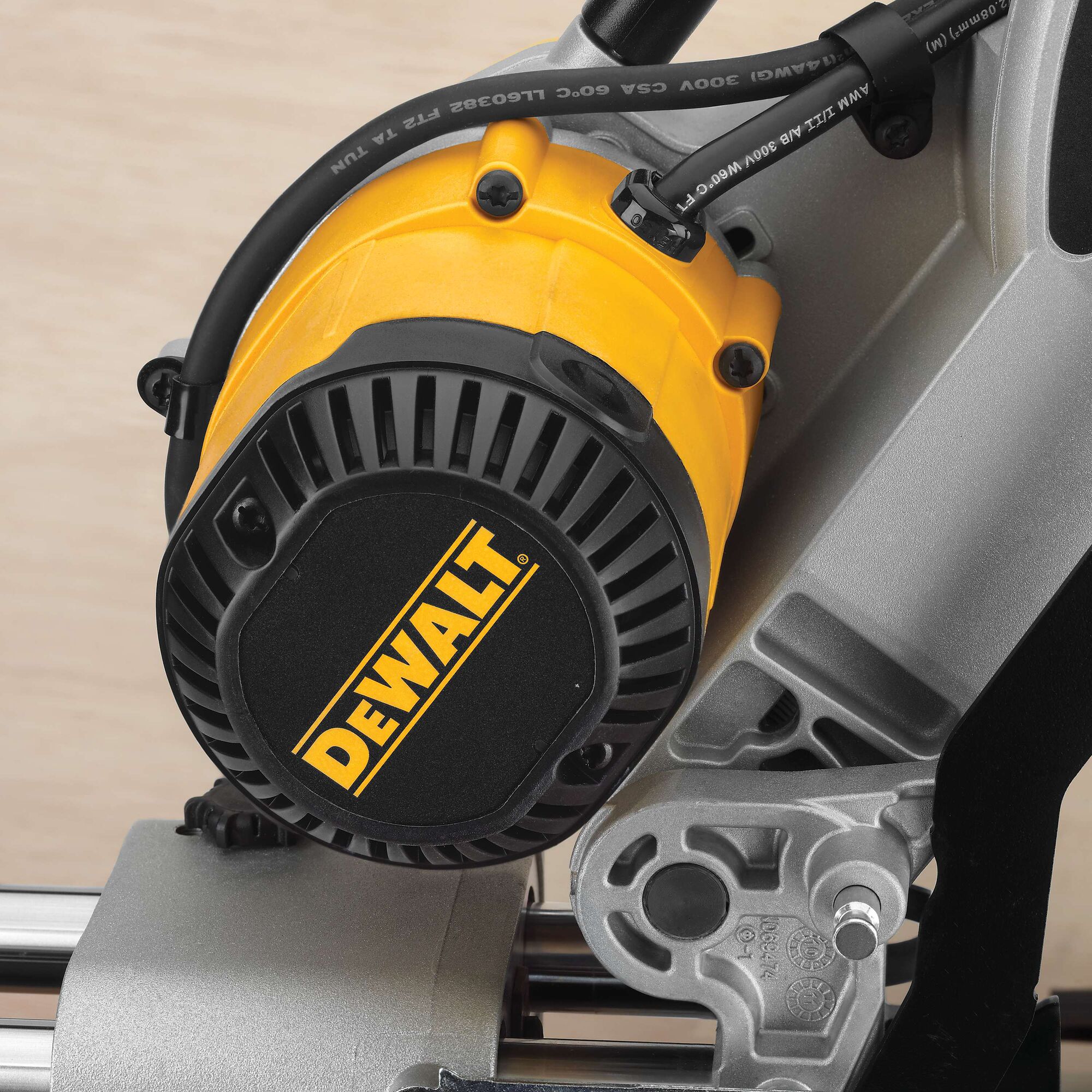 Close-up view of the motor assembly of a DEWALT power tool, featuring a yellow and black housing with visible brand logo and metal components.