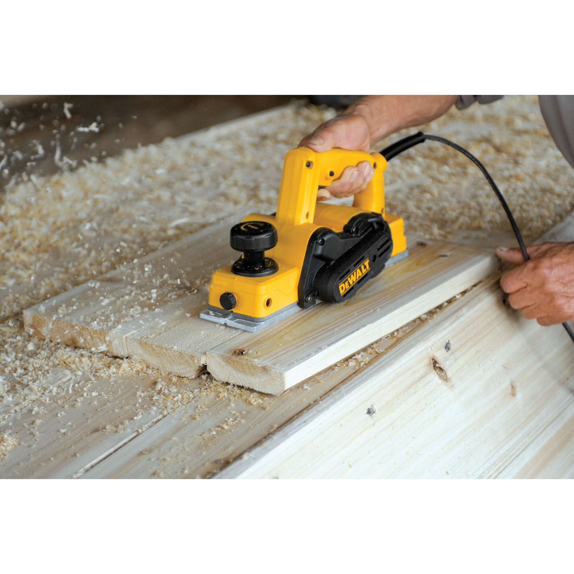 DEWALT Person using Portable Hand Planer to cut wood